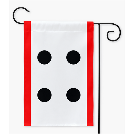 Mockup of a rectangular garden flag on a black metal flag stand. The flag has a narrow red stripe running vertically along the left and right edges. The centre is a white field with four black dots in teh centre. The dots are placed like the four corners of a square.