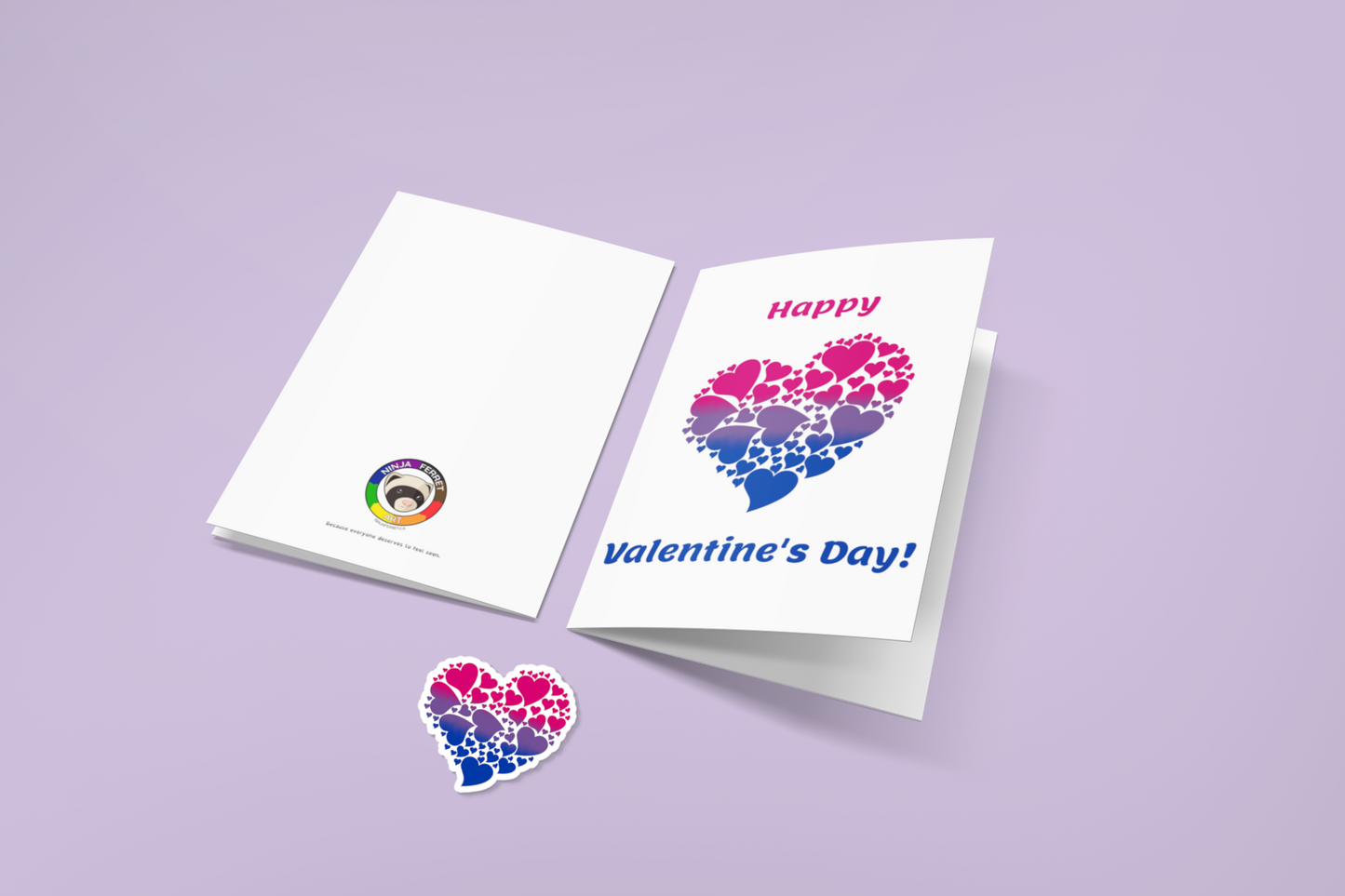 Mock up of two greeting cards, one showing the back (with the Ninja Ferret logo), and the other showing text: Happy Valentine's Day! and a heart made up of smaller hearts, coloured with a gradient of the bisexual flag. A sticker that matches the heart is also shown.