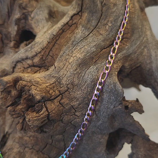 Short video of the figaro chain necklace hanging from a piece of driftwood. The video rotates side to side, then up an down, to show the shine and colour variation.