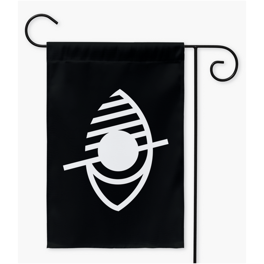 Mockup image of a rectangular garden flag on a black metal flag stand. The flag is black, with the symbol of a stylized eye drawn in white. There are white diagonal lines through half, and a longer diagonal as a slash mark though the centre.
