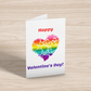 Mockup of a greeting card showing text: Happy Valentine's Day! and a heart made up of smaller hearts, coloured with a gradient of the original rainbow flag.