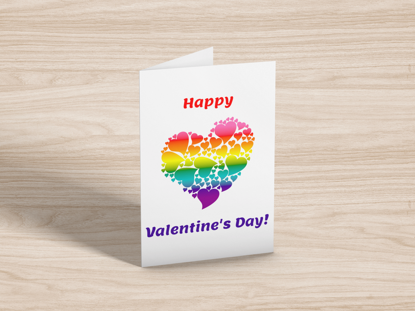 Mockup of a greeting card showing text: Happy Valentine's Day! and a heart made up of smaller hearts, coloured with a gradient of the original rainbow flag.