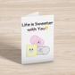 A greeting card on light wood background. The card has a white background. At the top is the text, "Life is Sweeter with You!" in the queerplatonic pride flag colours. Below are matching pink, yellow, and grey cartoon marshmallows with cute expressions. 